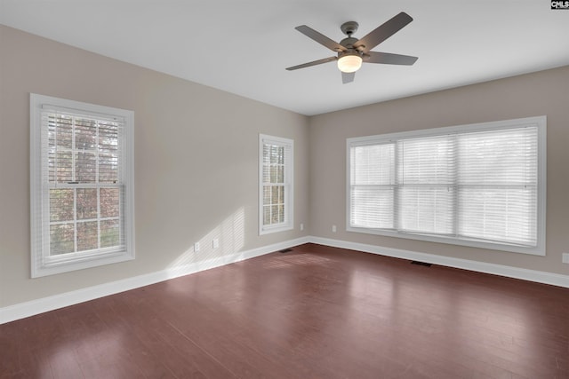 unfurnished room with dark wood-type flooring and ceiling fan