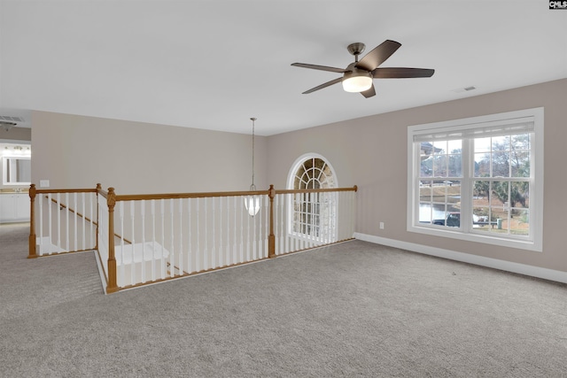 unfurnished room with ceiling fan and carpet flooring