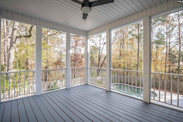 unfurnished sunroom featuring ceiling fan