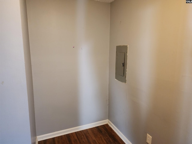 unfurnished room featuring dark hardwood / wood-style flooring and electric panel