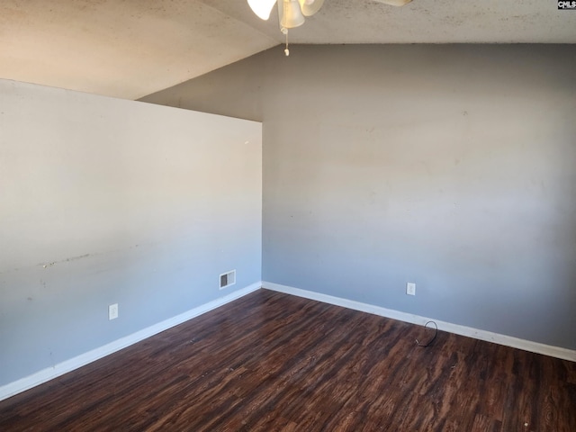 spare room featuring ceiling fan, lofted ceiling, and dark hardwood / wood-style flooring