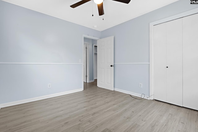 unfurnished bedroom with ceiling fan, a closet, and light hardwood / wood-style flooring