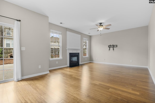 unfurnished living room with ceiling fan and light hardwood / wood-style flooring