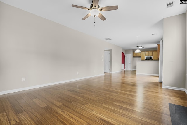 unfurnished living room with light hardwood / wood-style flooring and ceiling fan