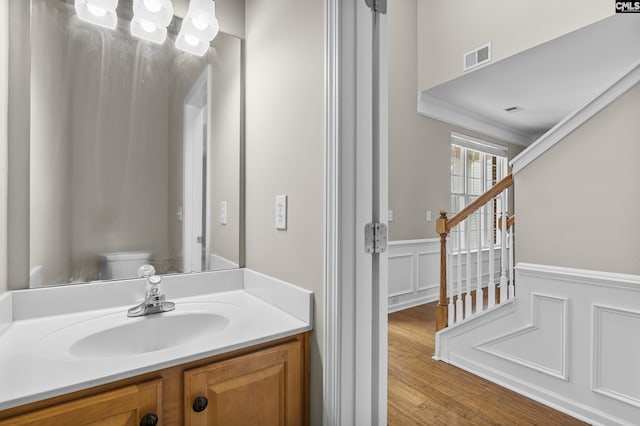 bathroom featuring vanity, wood-type flooring, and toilet