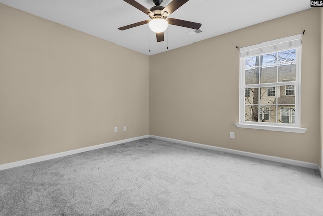 spare room featuring ceiling fan and carpet flooring