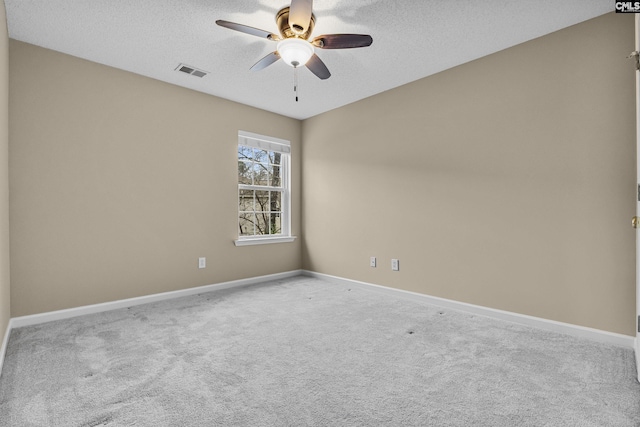 empty room featuring a textured ceiling, ceiling fan, and carpet flooring