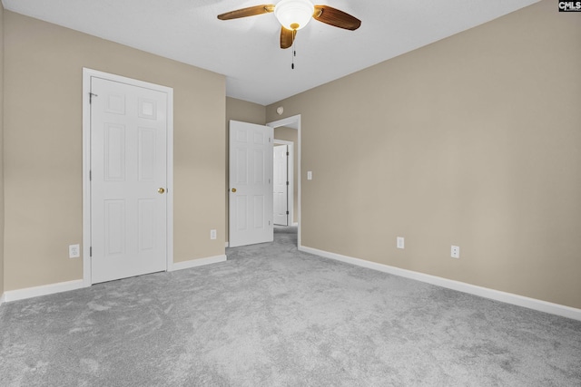 unfurnished bedroom with ceiling fan and carpet