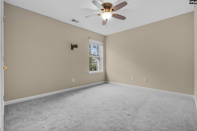 unfurnished room with ceiling fan, carpet, and a textured ceiling