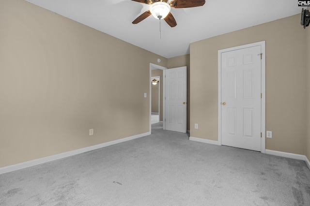 unfurnished bedroom featuring light colored carpet and ceiling fan