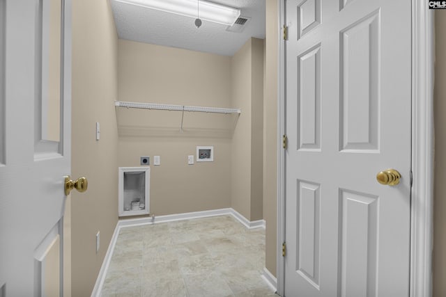 laundry area with hookup for an electric dryer, hookup for a washing machine, and a textured ceiling