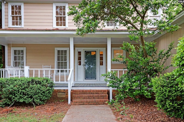 view of exterior entry featuring a porch