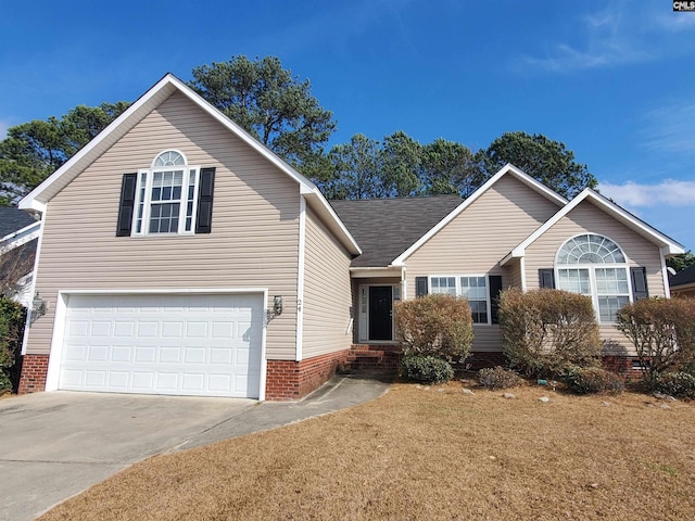 view of front of property with a garage and a front yard