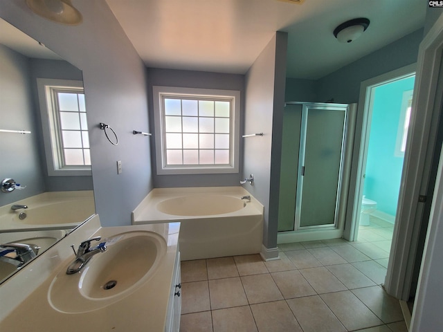 full bathroom with tile patterned flooring, vanity, separate shower and tub, and toilet