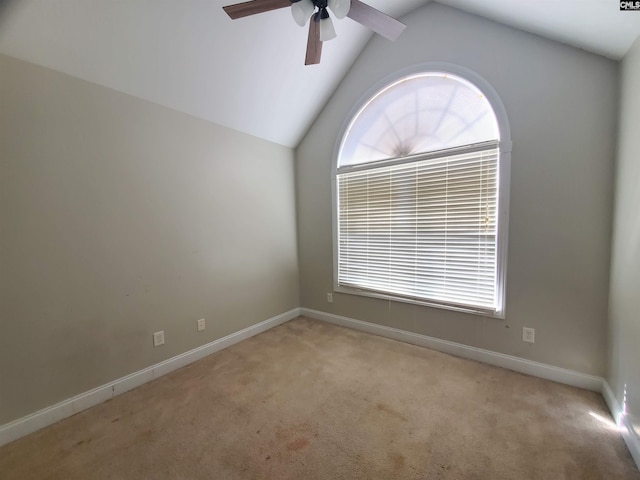 unfurnished room featuring lofted ceiling, light colored carpet, and ceiling fan