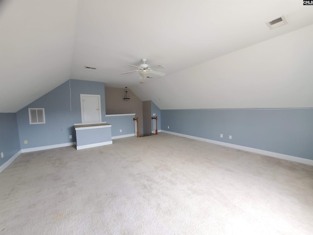 additional living space with lofted ceiling, light colored carpet, and ceiling fan