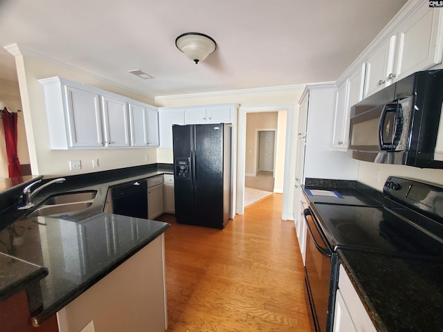 kitchen with black appliances, sink, white cabinets, kitchen peninsula, and light wood-type flooring