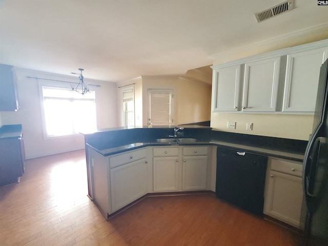 kitchen featuring sink, white cabinetry, wood-type flooring, kitchen peninsula, and black appliances