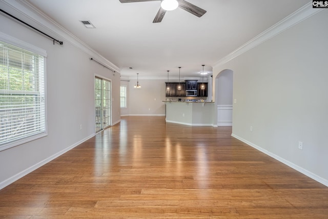 unfurnished living room featuring ornamental molding, ceiling fan, and light hardwood / wood-style floors