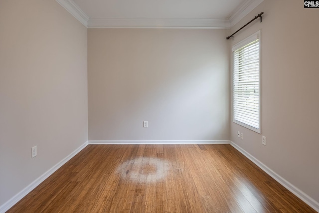 unfurnished room featuring crown molding and light wood-type flooring