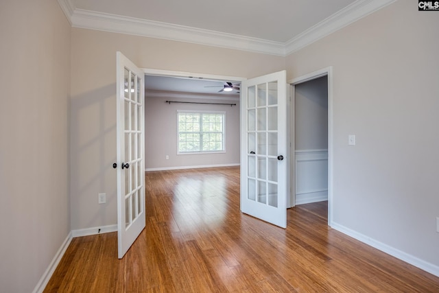 spare room with crown molding, light hardwood / wood-style flooring, and french doors