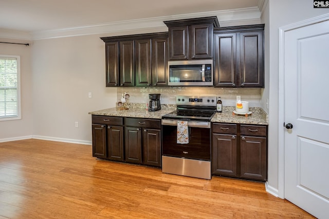 kitchen featuring dark brown cabinetry, tasteful backsplash, light wood-type flooring, ornamental molding, and stainless steel appliances