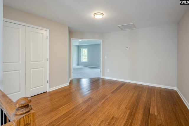 unfurnished room with hardwood / wood-style flooring