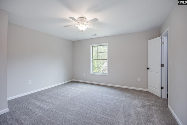 empty room with ceiling fan and carpet flooring