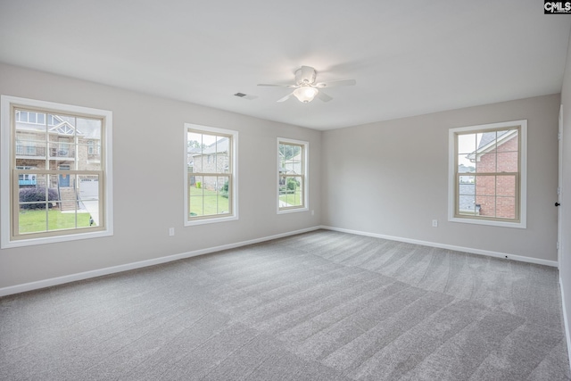 carpeted empty room featuring ceiling fan