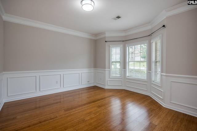 empty room with crown molding and wood-type flooring