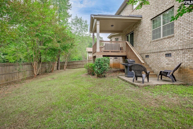 view of yard featuring a deck and a patio area