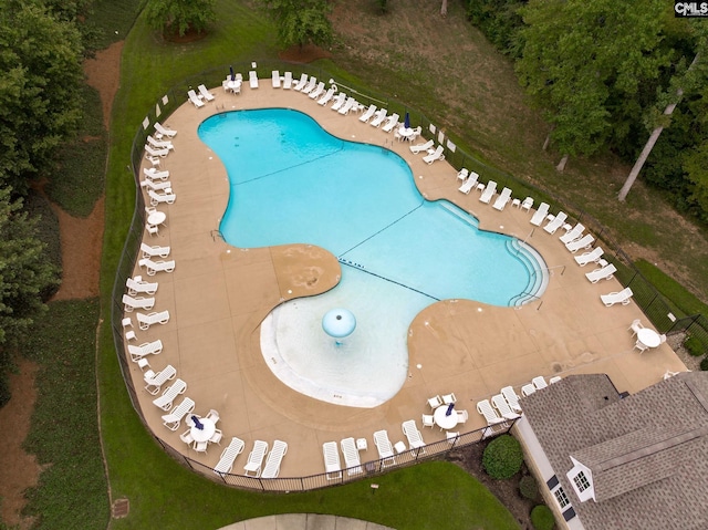 view of pool with a lawn