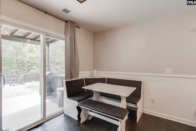 dining room featuring breakfast area and dark hardwood / wood-style floors