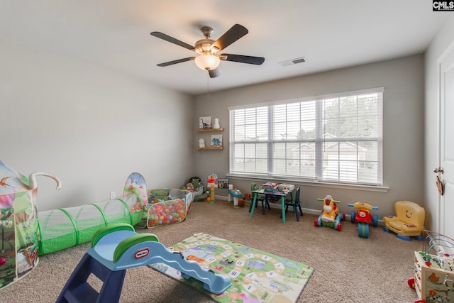 playroom with carpet floors and ceiling fan