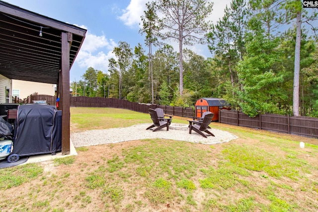 view of yard with a storage shed and a fire pit