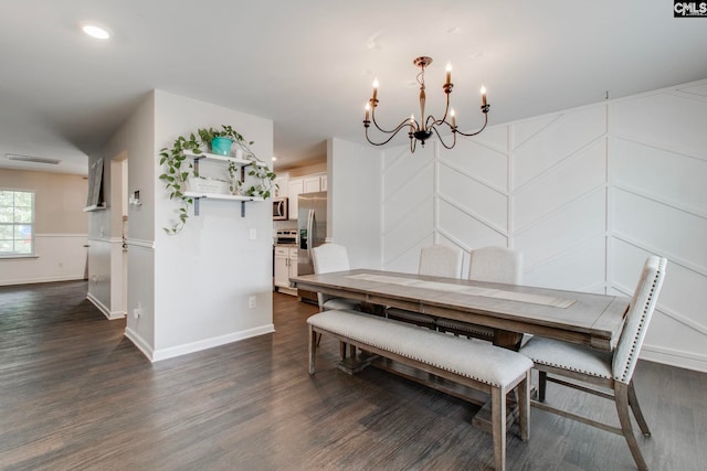 dining space featuring a notable chandelier and dark hardwood / wood-style flooring