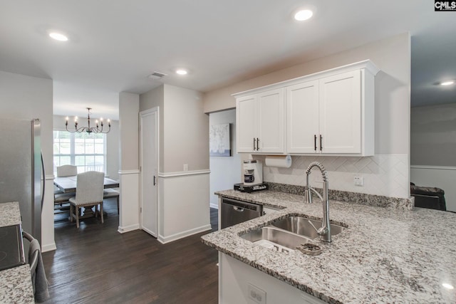 kitchen featuring appliances with stainless steel finishes, white cabinetry, sink, light stone counters, and dark wood-type flooring