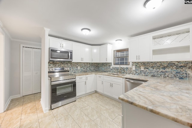 kitchen featuring sink, backsplash, white cabinets, light stone counters, and stainless steel appliances