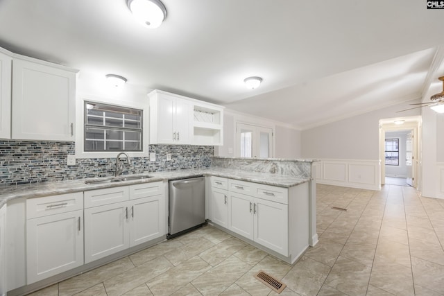 kitchen with white cabinetry, sink, vaulted ceiling, and stainless steel dishwasher