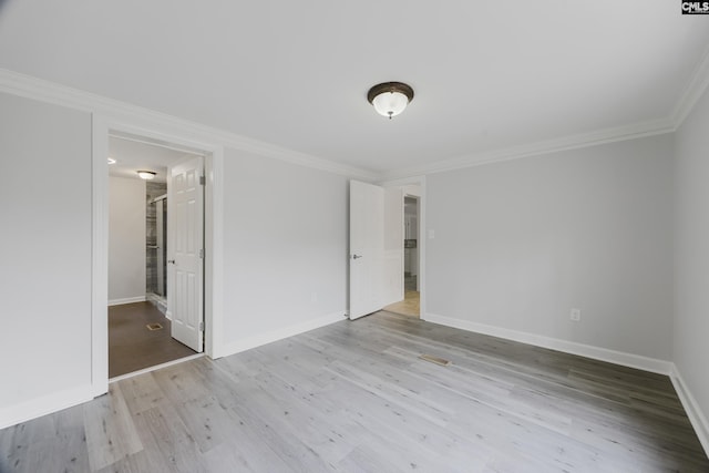 spare room with crown molding and light hardwood / wood-style floors