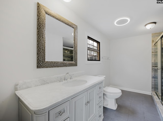 bathroom with vanity, an enclosed shower, and toilet