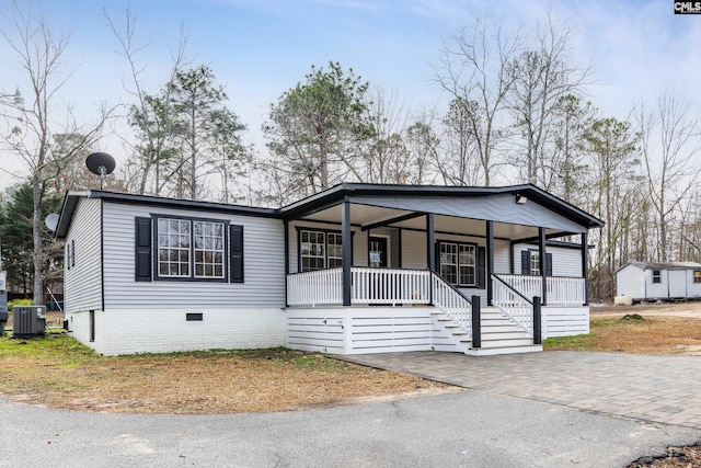 view of front of house with cooling unit and a porch