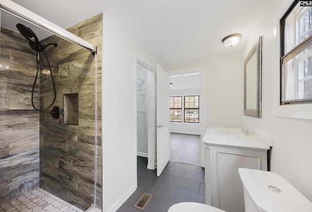 bathroom with an enclosed shower, vanity, tile patterned flooring, and toilet