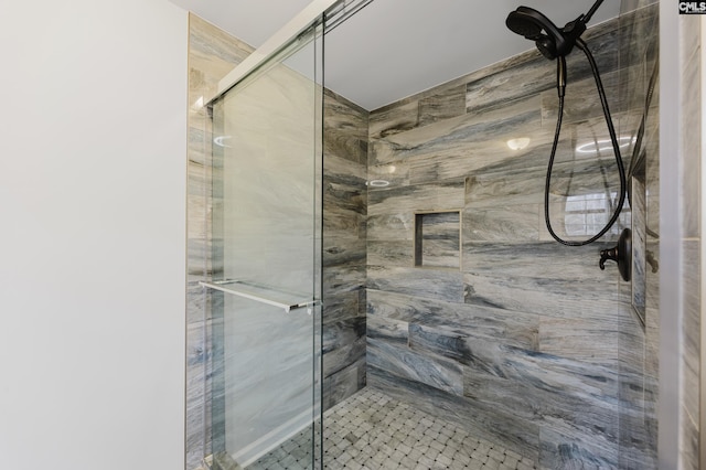 bathroom with a shower with door