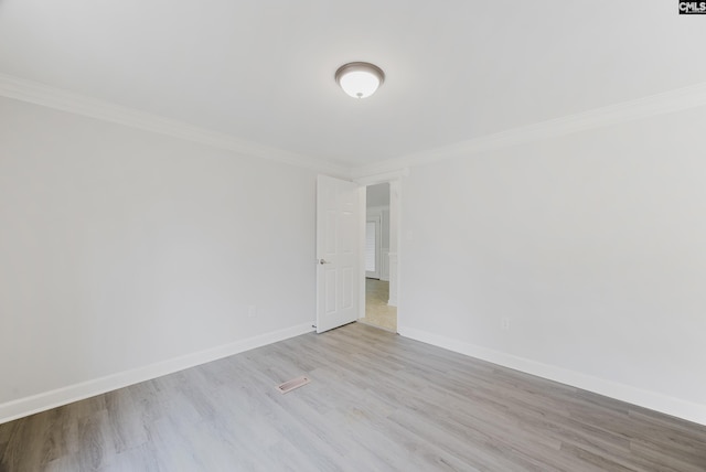 unfurnished room with crown molding and light wood-type flooring