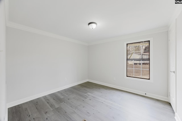 spare room with crown molding and light hardwood / wood-style floors