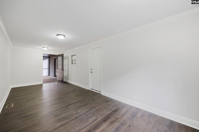 empty room with dark wood-type flooring and ornamental molding