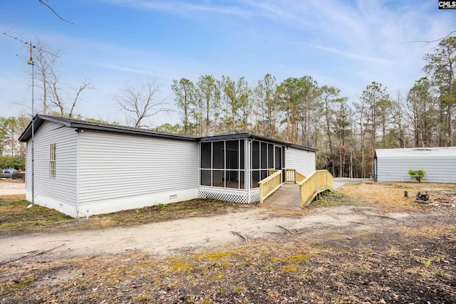 back of property with a sunroom