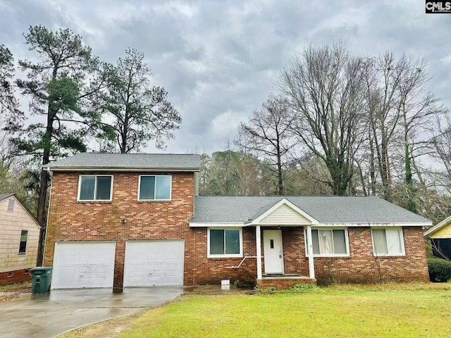 view of front of property with a garage and a front lawn