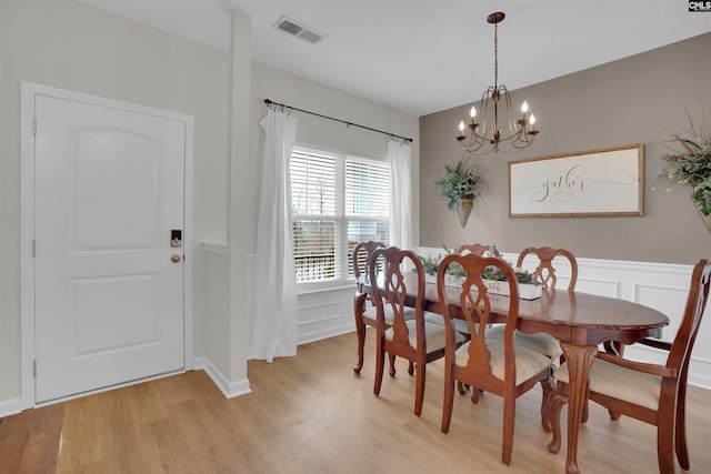 dining room featuring light hardwood / wood-style floors and a notable chandelier